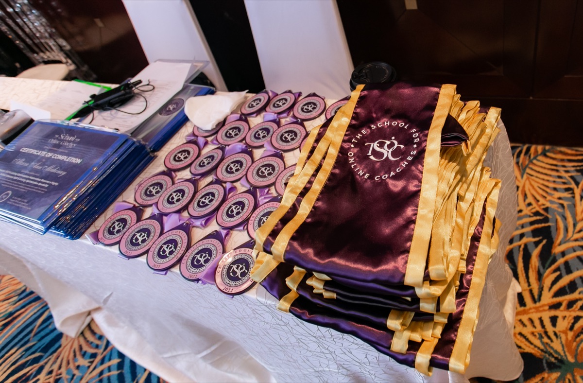 Certificates, medals and sashes laid out for The School for Online Coaches graduation